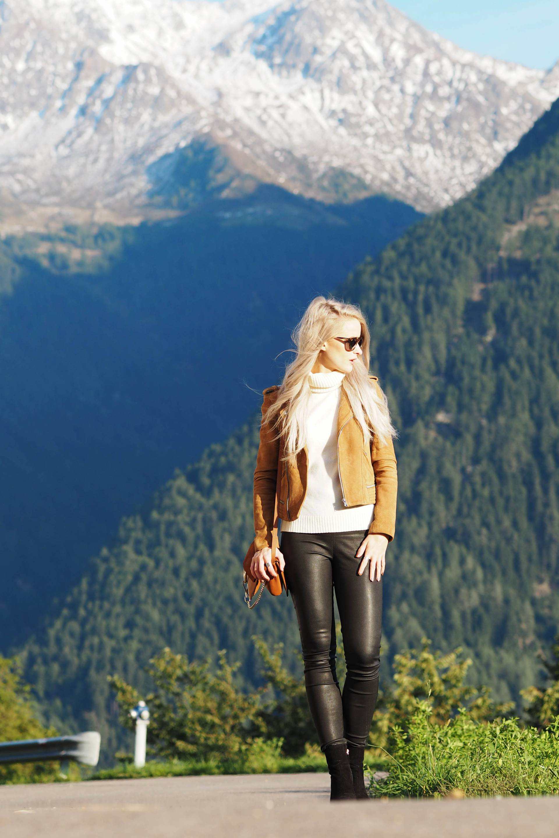 white hair inthefrow in south tyrol, north italy in revolve clothing and Maje suede jacket